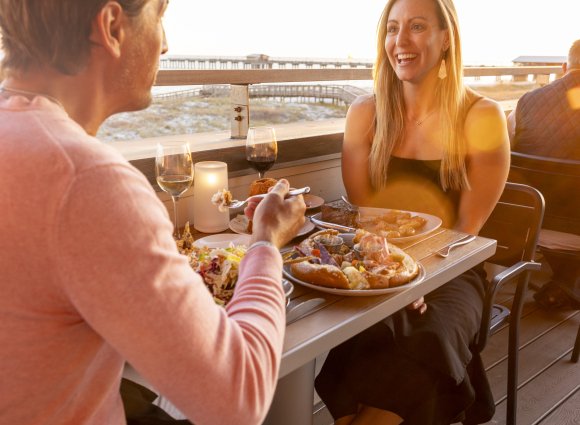 A couple enjoying a meal together on Alabama's Beaches