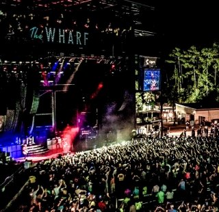 Aerial view of an outdoor concert at The Wharf Amphitheater in Orange Beach