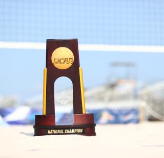 NCAA Beach Volleyball Championship Trophy on the sand court at Gulf Shores