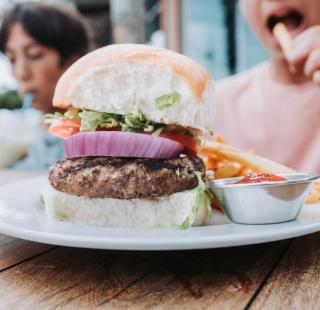 Delicious burger with homemade buns at Cobalt waterfront restaurant in Orange Beach