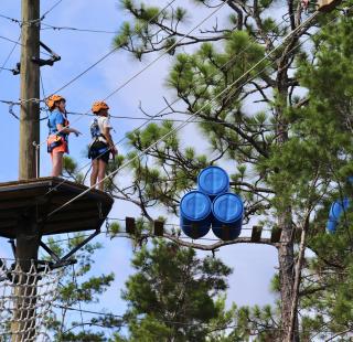 Campers on the ropes course at the Gulf Coast Eco Center