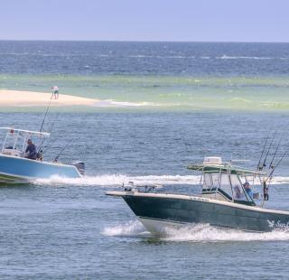 Boats cruising near The Perdido Pass Bridge in Orange Beach