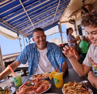 Family dining at Sea-N-Suds beachfront seafood restaurant in Gulf Shores