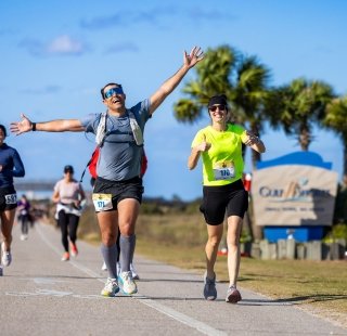 Runners racing along the beach boulevard during the Coastal Half Marathon in Orange Beach