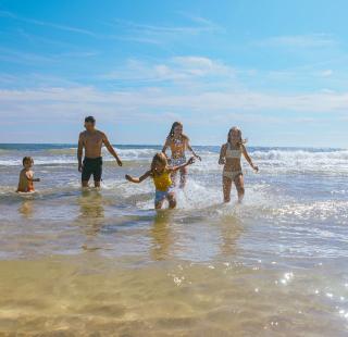 Family splashing in the beach in Gulf Shores