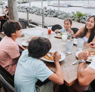 Family dining outside at Cobalt waterfront restaurant in Orange Beach