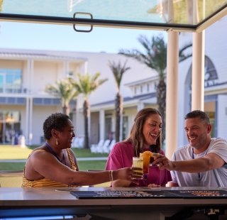 Friends having a drink and a meal at Tee Off at The Wharf