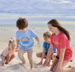 Local children in their Alabama's Beaches merchandise