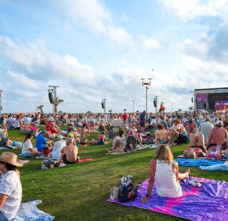 Crowd relaxing on the lawn at Sand in My Boots Music Fest in Gulf Shores