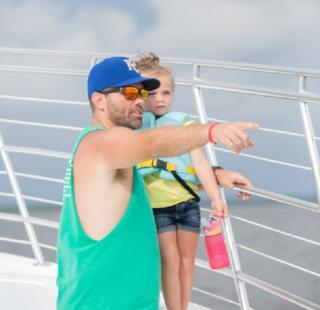 father and daughter watching dolphins in Orange Beach AL