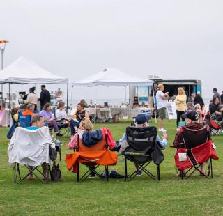 People sitting in lawn chairs at the Annual Coastal Alabama Food Truck & Craft Beer Festival in Gulf Shores