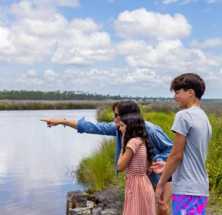 Family looking out onto Lake Shelby in Gulf State Park