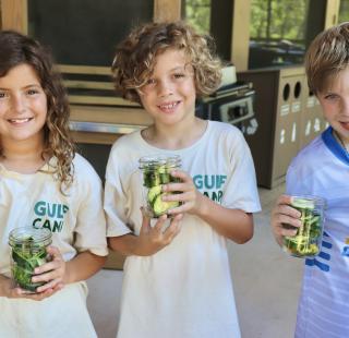 Children proudly showing off their pickles they made at the Gulf Coast Eco Center