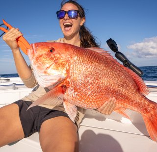 Girl with a red snapper caught on Alabama's Beaches