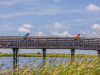 People biking over Lake Shelby in Gulf State Park