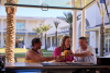 Friends enjoying drinks at Tee Off bar and TopGolf Swing Suites in Orange Beach
