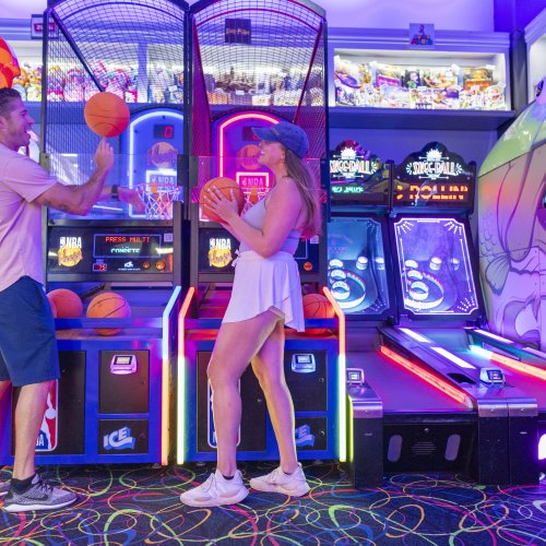 A couple playing game at The Track arcade.