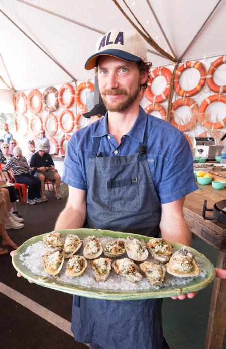 Man holding tray of Oysters at The Hanout Oyster Cookoff in Gulf Shores AL