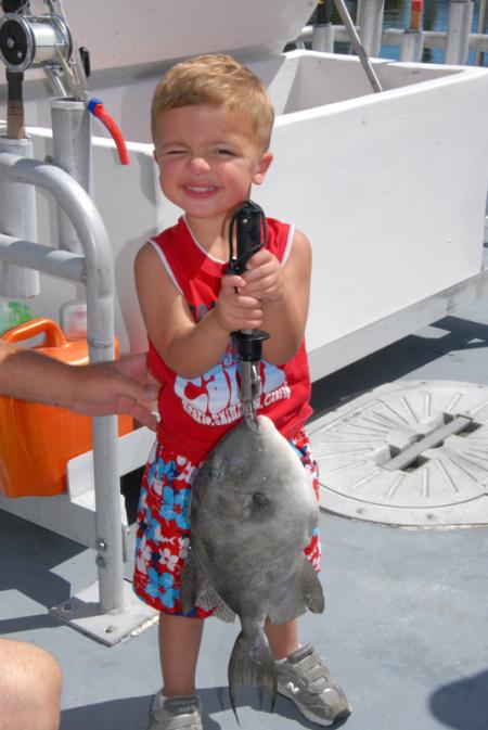 Young Boy holding fish