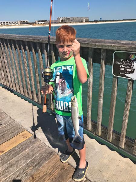 Boy holding catch at Gulf State Park Pier