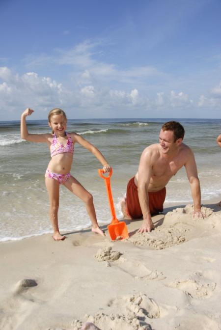Daddy and Daughter Having Fun at the Beach