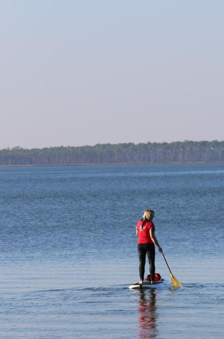 Woman paddleboarding in Orange Beach, AL