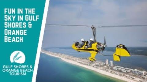 Play the video titled Fun in the Sky in Gulf Shores & Orange Beach | Helicopter Tours, Gyroplanes, Parasailing, & More!